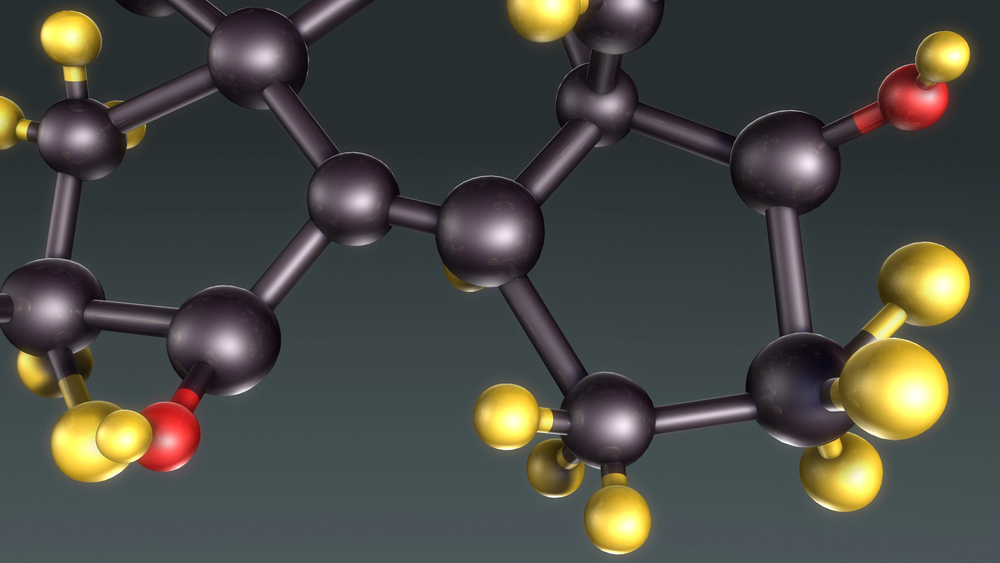 3D molecular structure model with black carbon atoms, yellow hydrogen atoms, and red oxygen atoms on dark background.